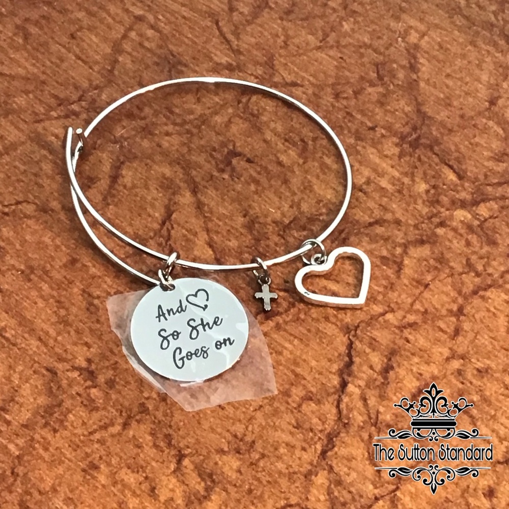 Bangle bracelet Charms cross heart So she goes on.